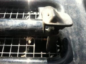 Washer nozzle gets relocated into the grate below the windshield in the middle of the Jeep